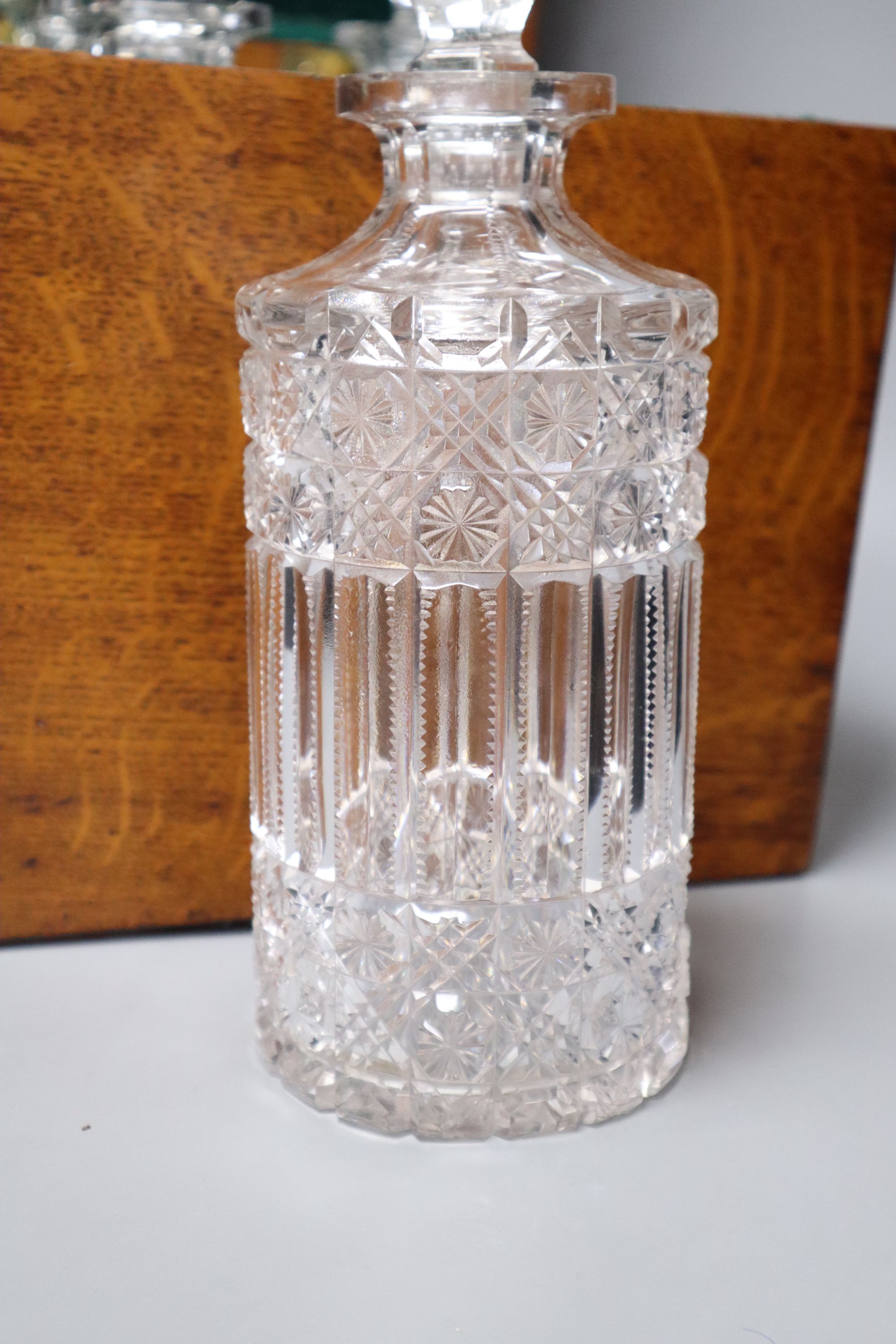 A Victorian oak four decanter box containing two pairs of cut glass decanters, overall height 30cm